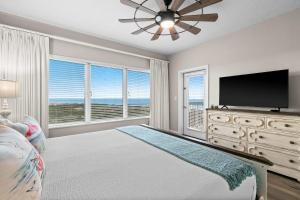 a bedroom with a bed and a flat screen tv at TOPS'L Summit 809 2 Bedroom in Destin +22 photos