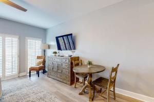 a dining room with a table and a dresser at 4th-Floor Condo with Shared Pool and WiFi in Destin