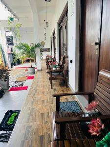 a hallway with benches and tables in a building at Saffron Swell Villa in Arugam Bay +84 photos