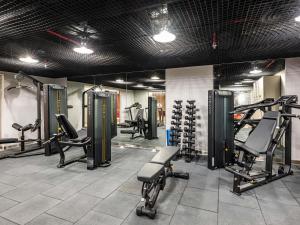 a gym with several treadmills and machines in it at Ibis Riyadh Hotel Al Muhammadiyah United Company Branch in Riyadh