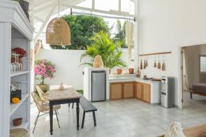 a kitchen with a table and a dining room at Uluwatu - Beach Villa 5 in Uluwatu