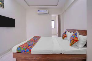 a bedroom with a large white bed with at FabHotel Red Rose Palghar in Nale Sopāra