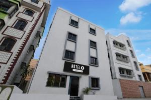 a white building with a sign for a hotel at Super Hotel O Acropolis Mall Kolkata Formerly The Orchid Residency in Kolkata