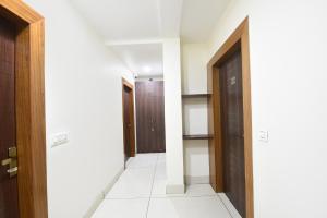 a hallway with two doors at FabHotel Samarth Residency By the Arrow in New Delhi