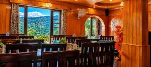 a dining room with a view of a mountain at Pine view in Gulmarg
