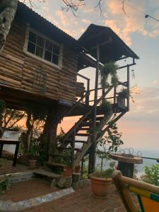 a tree house with a staircase leading up to it at Cabañas La PetiteChef in El Limar
