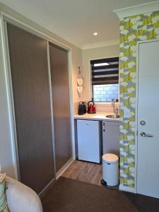 a small kitchen with a sink and a counter at Ra-ata Farm in Rangiora +11 photos