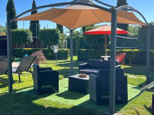 an umbrella and two chairs and a table under it at RelaxHomeHoliday in Panicale +56 photos