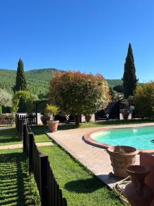 a backyard with a swimming pool and a fence at RelaxHomeHoliday in Panicale