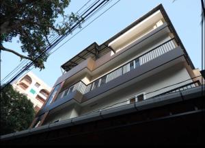 a building with a blue and white facade at New Castle Residency in Cochin