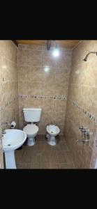 a bathroom with two toilets and a sink at Cabaña Kuarahy in Empedrado +7 photos