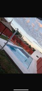 a view of a swimming pool next to the ocean at Cabaña Kuarahy in Empedrado