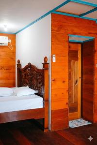 a bedroom with two beds and an open door at Baruk Homestay in Katiet
