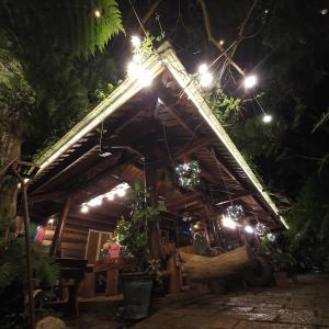 a wooden house with lights on it at night at tropical garden homestay in Lien Khuong Airport +10 photos