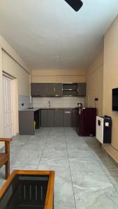 an empty kitchen with a stove and a microwave at New Castle Residency in Cochin