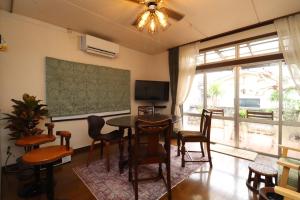 a living room with a table and chairs and a television at Casa di acero in Kikuchi +42 photos