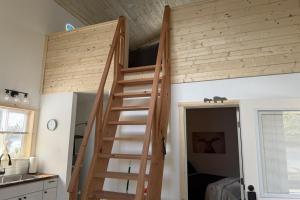 a loft bed in a tiny house at Seward Mountain View Cabins #6 in Seward