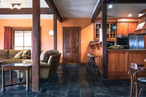 a living room with a couch and a table at The George at Yering in Yering