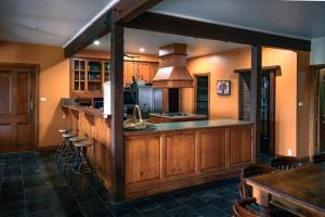 a kitchen with wooden cabinets and a counter with stools at The George at Yering in Yering