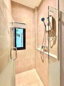 a bathroom with a shower with a glass door at Ana's House in Nathon Bay +19 photos