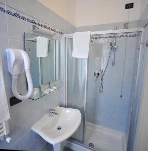 a bathroom with a sink and a shower at Hotel Riviera Blu in Tirrenia