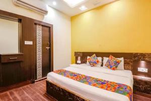 a bedroom with a large bed in a room at FabHotel Ambika Dx in Gwalior