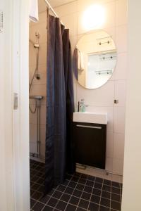 a bathroom with a sink and a mirror at Hotell Tinget in Sala