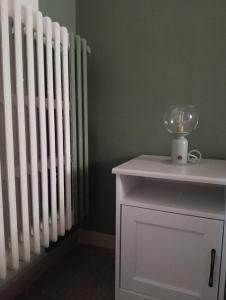 a white radiator in a room with a white cabinet at Liberty 21 in Andria +1 photo