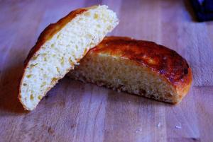 a piece of bread sitting on a cutting board at Agriturismo Girasole in Fai della Paganella