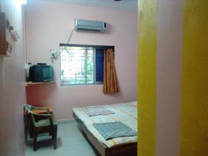 Postel nebo postele na pokoji v ubytování Hotel Anjali Lodge Malvan