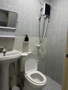 a bathroom with a shower and a toilet and a sink at The friendly stay in Male City