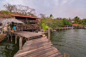 a wooden bridge over a body of water at Villas Isla Montosa in Coyuca de Benítez