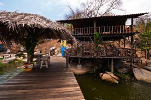 a wooden walkway leading to a resort with a building at Villas Isla Montosa in Coyuca de Benítez +54 photos