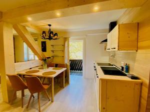 a kitchen with a table and chairs in a room at Wilderer Suiten Mariazell in Mariazell +55 photos