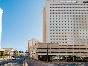 a tall white building with a street in front of it at ibis budget Porto Alegre - Super Econômico in Porto Alegre