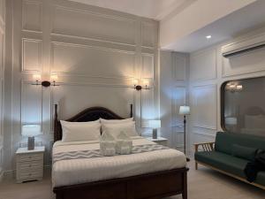 a bedroom with a bed and a green couch at Best House Luang Prabang in Luang Prabang +111 photos