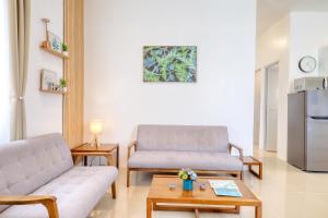 a living room with two couches and a coffee table at 3BR Guesthouse near Panglao - Pool Access - Bohol Tours - Fast WiFi in Dauis
