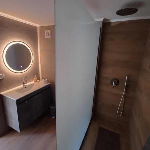 a bathroom with a sink and a mirror at The Forest Villa in Zacharo +12 photos