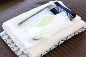 a basket with towels and a thermometer on a table at Oak Hotel Edo in Tokyo