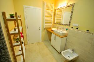 a bathroom with a sink and a toilet and a mirror at Apartment Sovica in Belgrade +14 photos