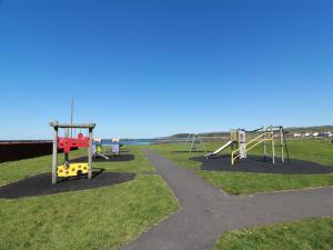 a park with three swings and a path at Rothiemay in Girvan
