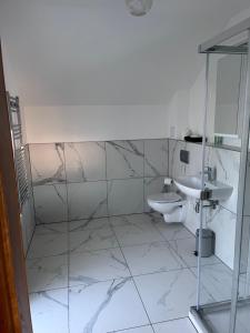 a bathroom with a sink and a toilet at Chameleon House in Dornoch +10 photos