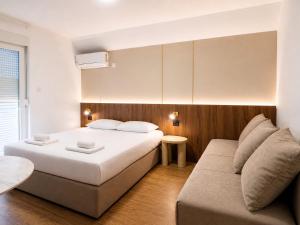 a bedroom with a bed and a couch at Tomm in Trebinje