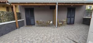 a patio with chairs and a table in a building at Soft landing at home in CTA