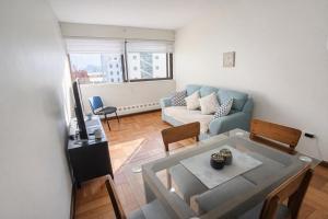 a living room with a couch and a table at Alojamiento Centro Osorno Plaza del Toro in Osorno