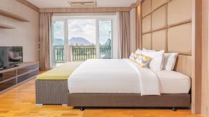 a bedroom with a large bed with a large window at Lacol Khao Yai - A Chatrium Collection in Mu Si +156 photos