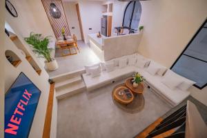 an overhead view of a living room with a couch and a table at 2BR villa w- pool & beach access in Mengwi
