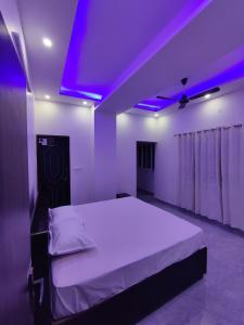 a bedroom with a bed with a purple ceiling at Heaven Heights in Rājpur