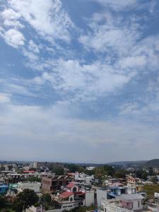 a city under a blue sky with clouds at Heaven Heights in Rājpur