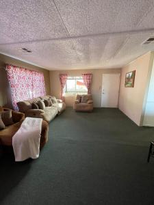 a large living room with couches and chairs in it at Casa Isabel in Ensenada